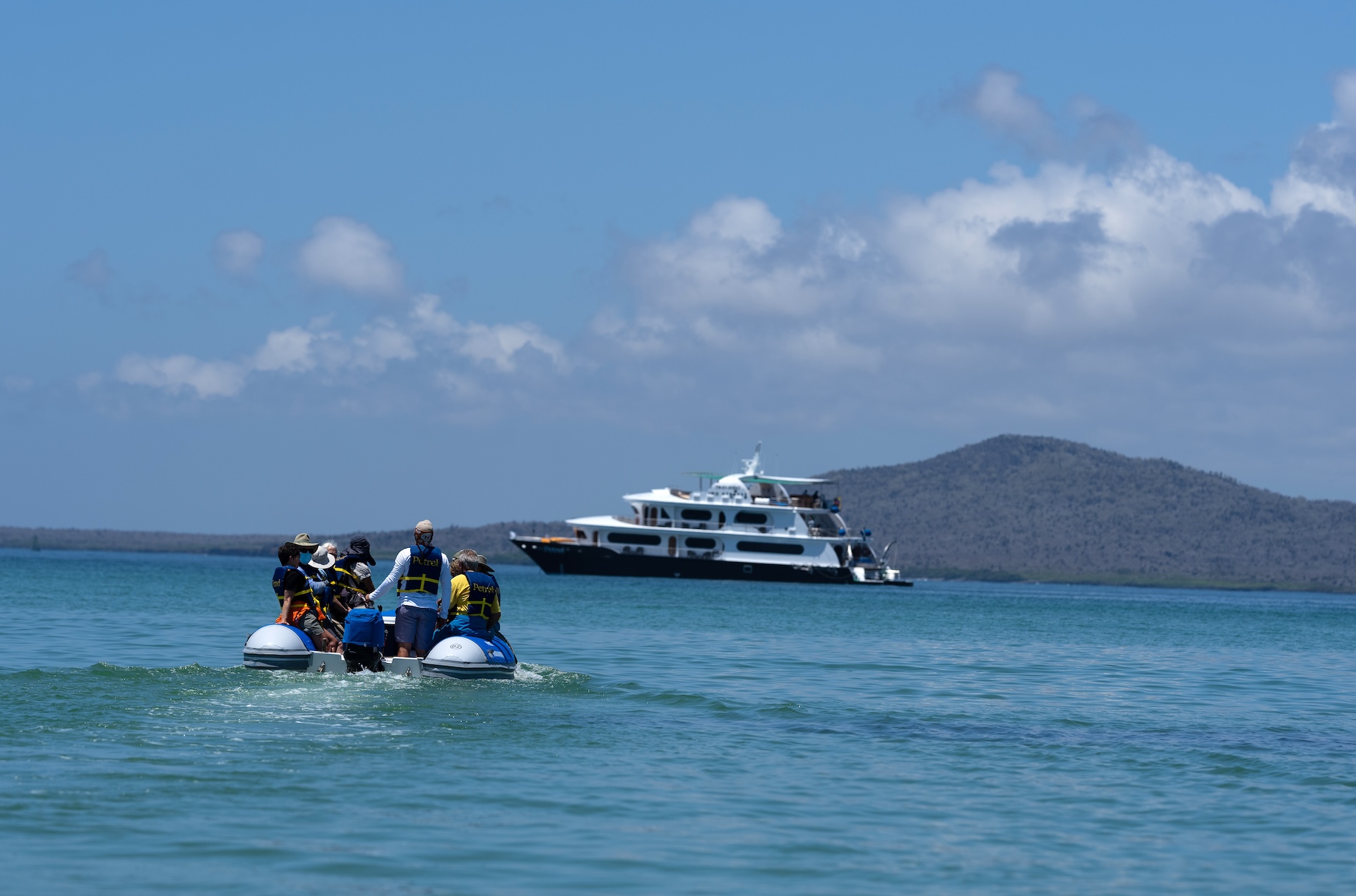 Natural Habitat Adventures guests cruise back to the Petrel ship by panga in the Galapagos