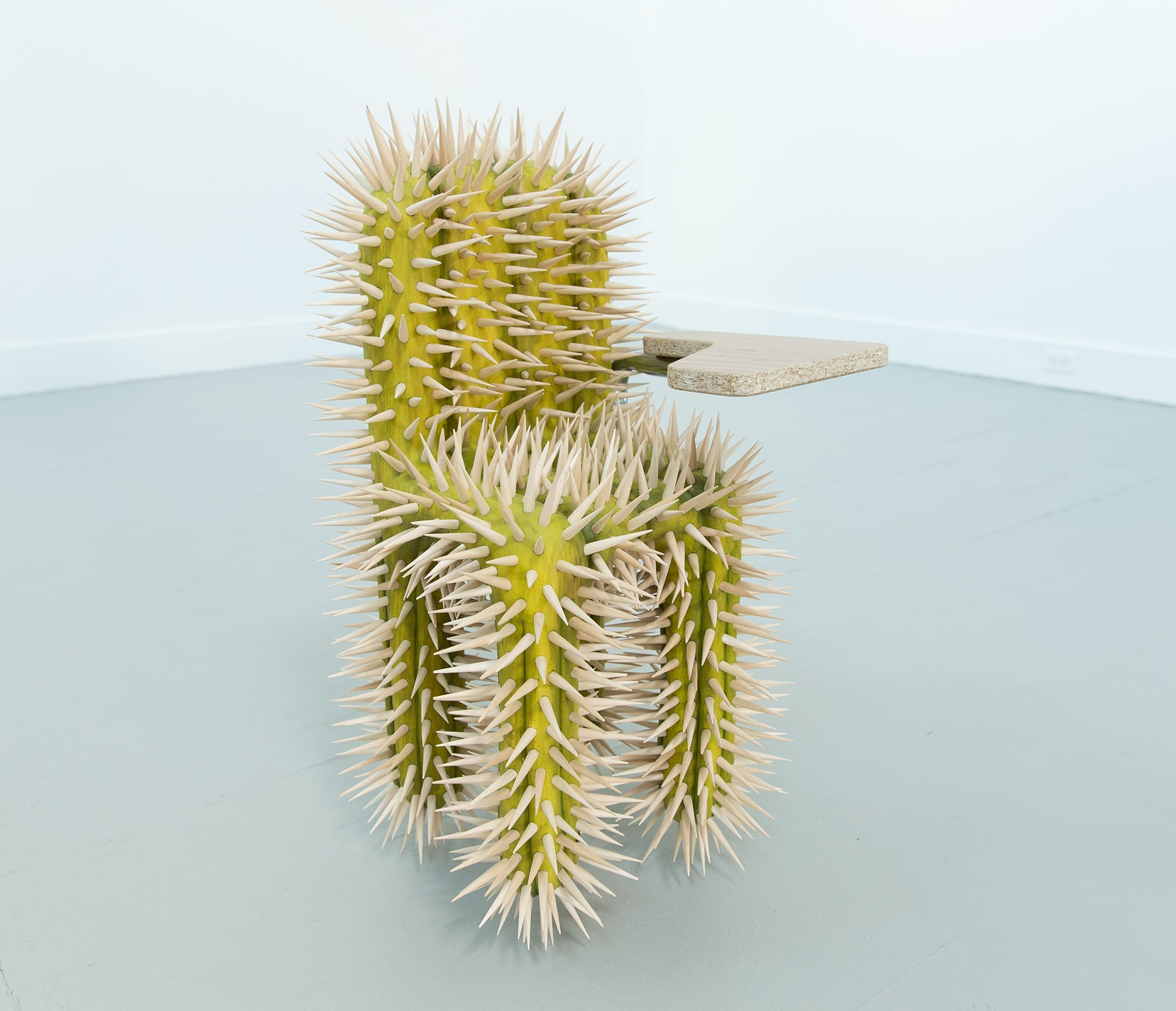 a school desk by Raul De Lara covered in cactus spines