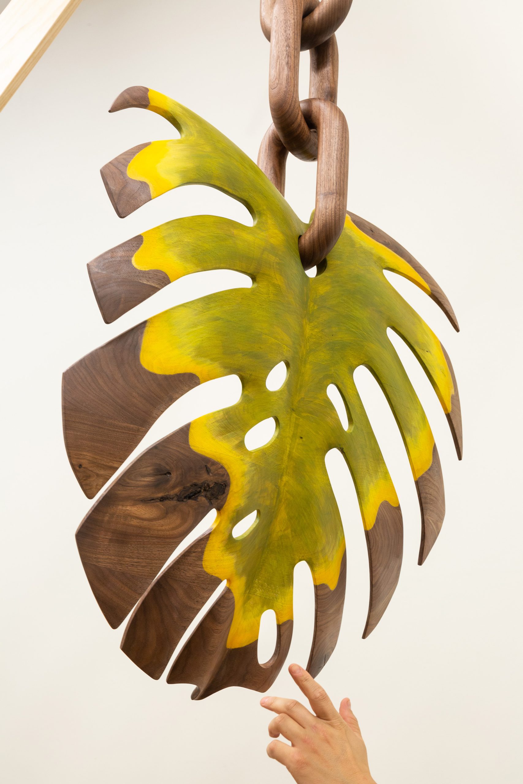 a wooden monstera leaf by raul de lara that's browning at the edges